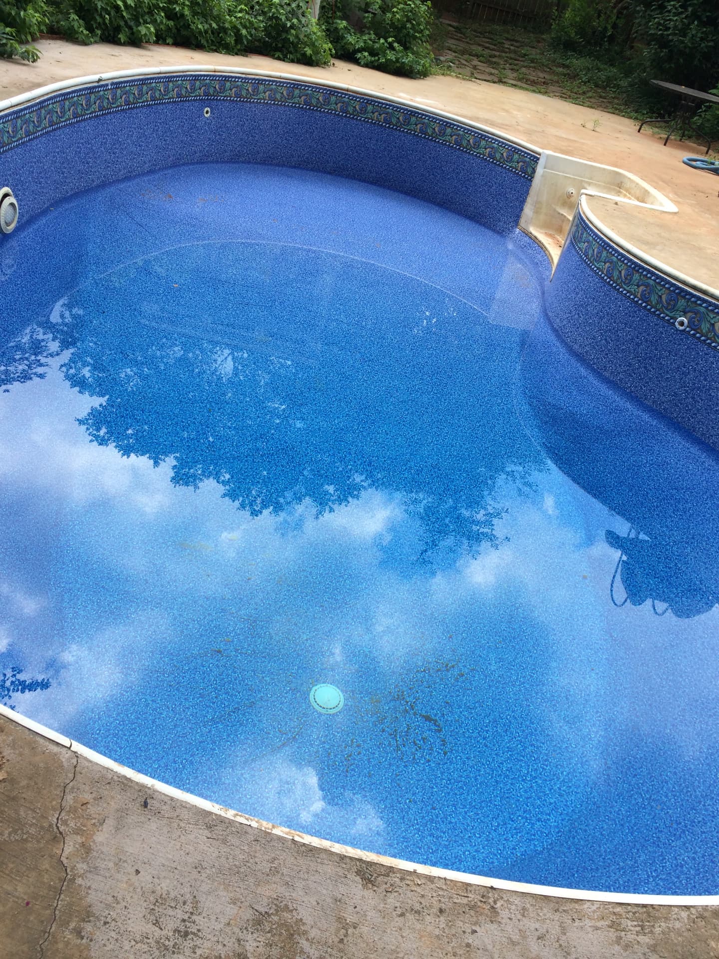 Freeform swimming pool after a new blue vinyl liner replacement by Pool People