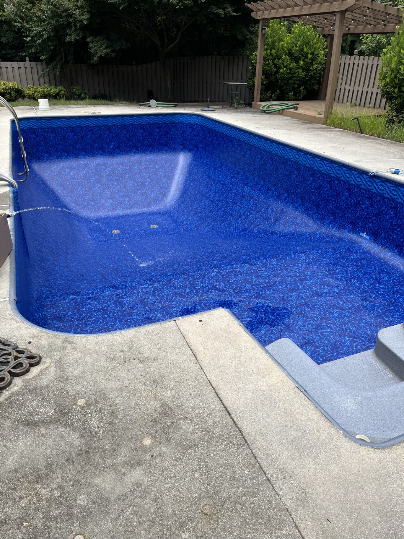 After swimming pool liner replacement in Winder GA — new deep blue vinyl liner installed by Pool People