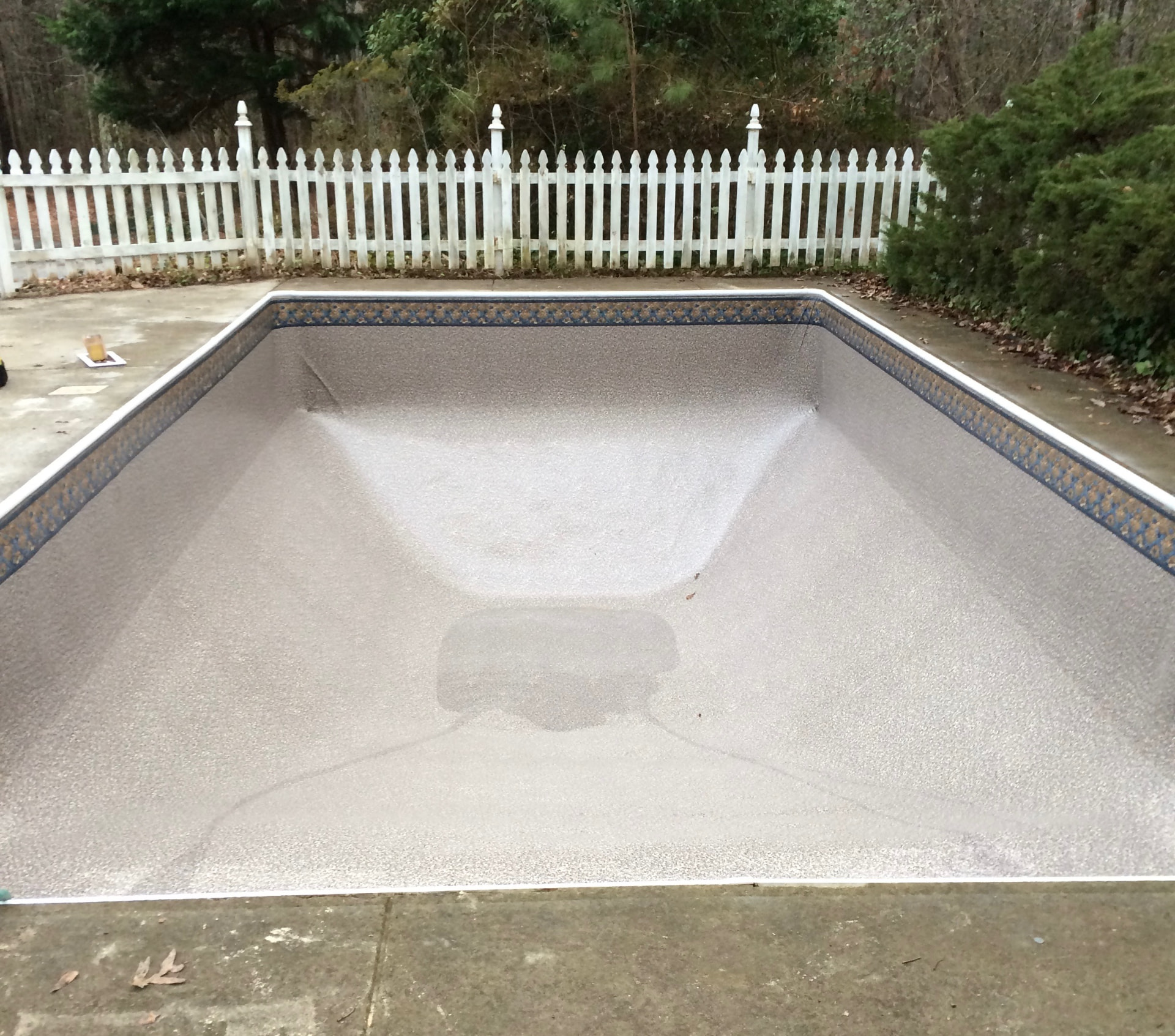 Same in-ground pool after Pool People installed a new vinyl swimming pool liner with tile-pattern border